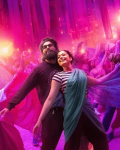 Allu Arjun and his co-star enjoying a vibrant dance scene in Pushpa 2, surrounded by colorful lights and flowing fabrics, creating a lively and festive atmosphere.